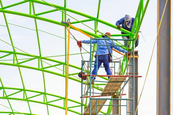 two-construction-workers-on-scaffolding-are-fixing-2025-03-11-12-20-01-utc