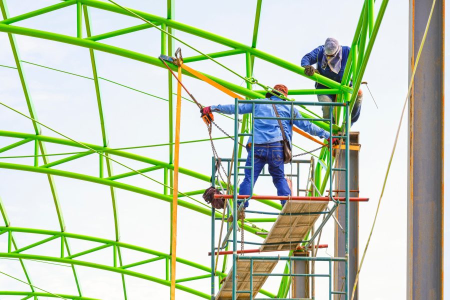 two-construction-workers-on-scaffolding-are-fixing-2025-03-11-12-20-01-utc